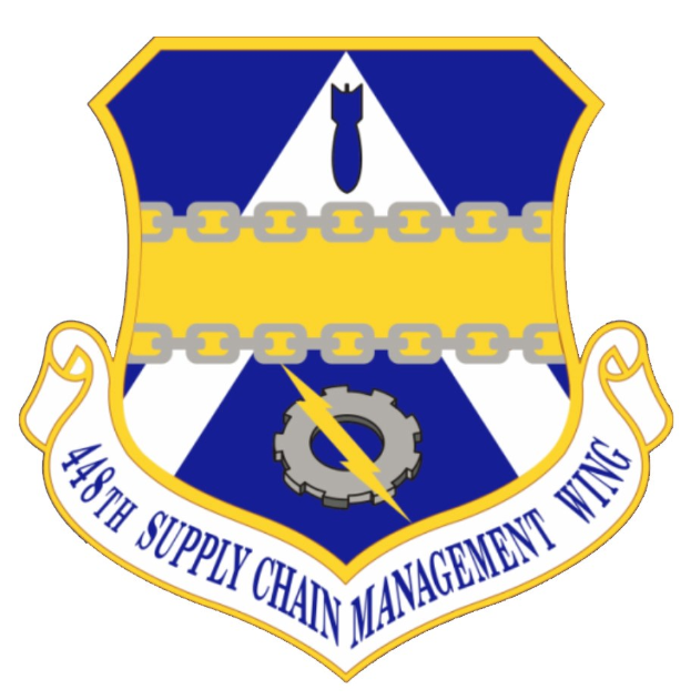 Logo des 48. Versorgungsgeschwader mit einem blauen Schild mit einem weißen Stern und einem weißen Banner mit der Aufschrift "Versorgungsgeschwader" in blau, alles in weiß mit schwarzer Schrift umrandet.