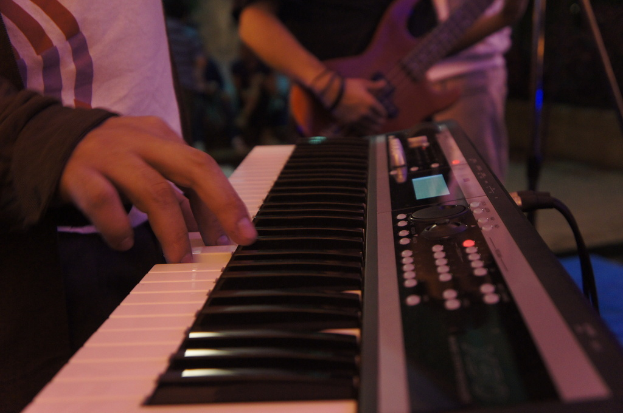 A person playing a Casio keyboard.