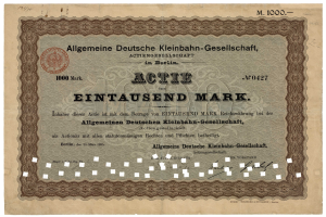 Ein altes deutsches Aktienzertifikat, ausgestellt von der deutschen Regierung, mit Text und einem Stempel.